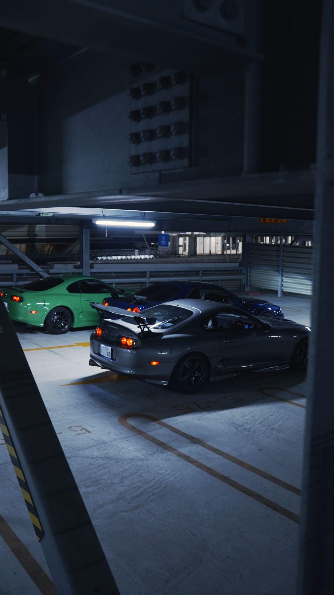 JDM cars parked together during a night tour
